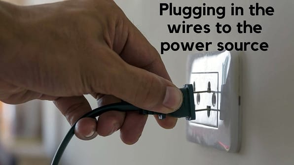 Plugging in the wires to the power source